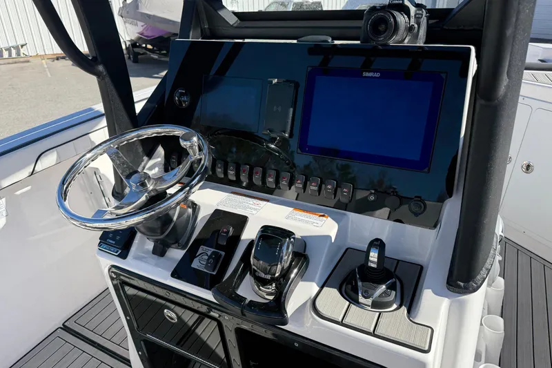 Slide: The Image of 2024 Yamaha Boats 255 FSH Sport H dashboard with steering wheel and control panel. - 9