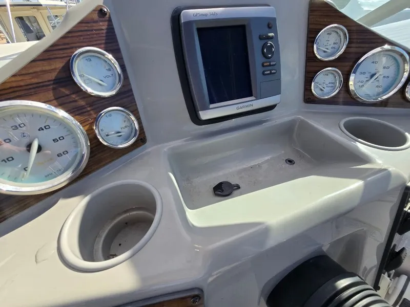 Slide: The Image of 2011 Bayliner 255 dashboard with gauges and Garmin GPS system. - 11