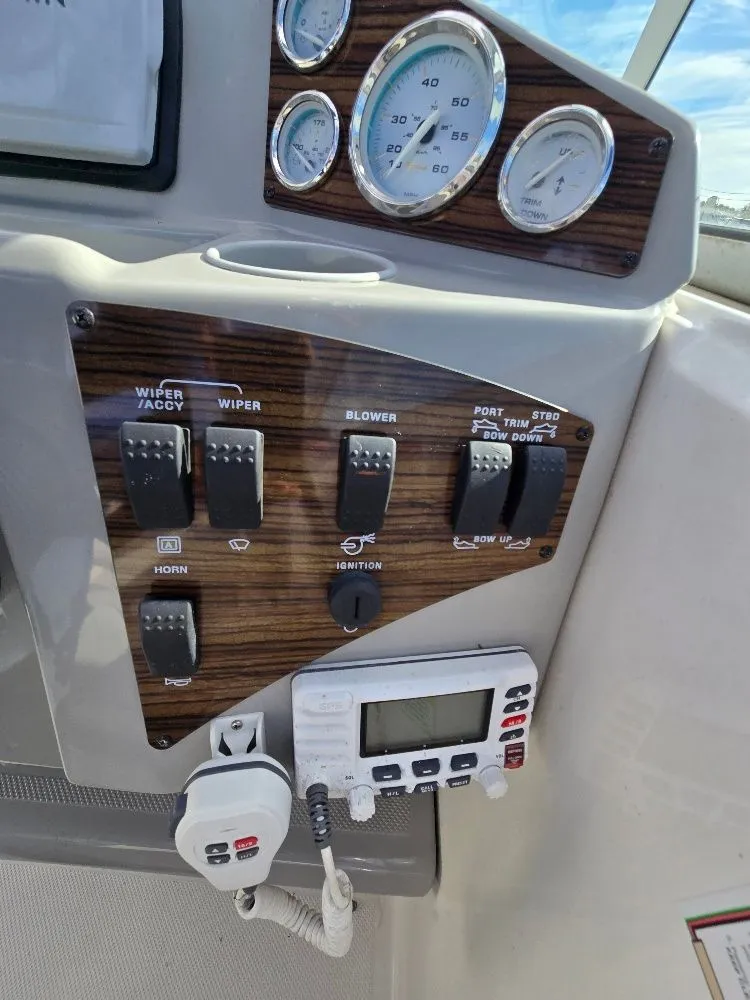 Slide: The Image of Control panel of a 2011 Bayliner 255 boat with gauges and switches. - 13
