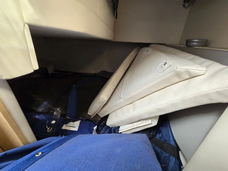Slide: The Image of Interior storage area of a 2011 Bayliner 255 boat with cushions and covers. - 14