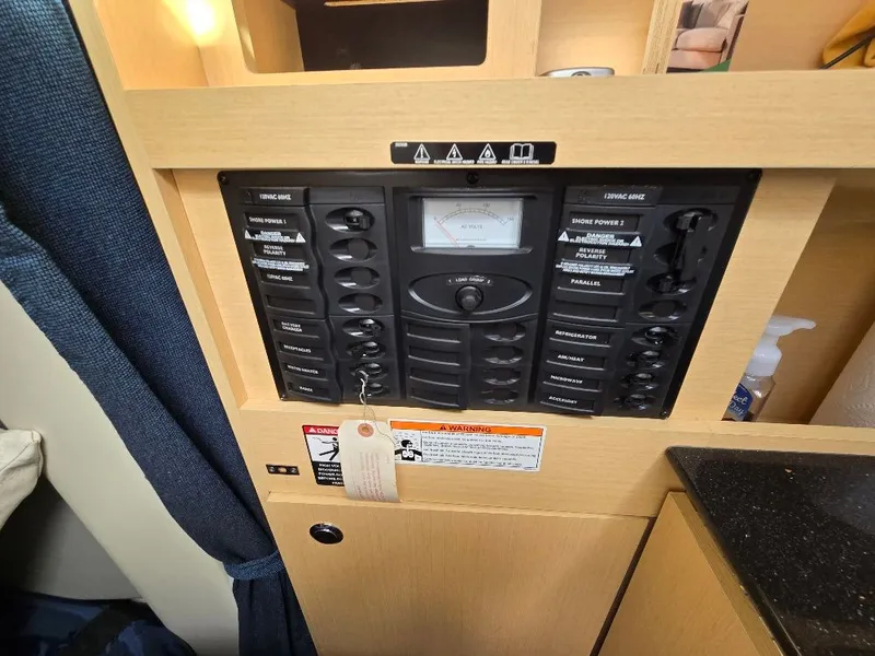 Slide: The Image of Electrical control panel in a 2011 Bayliner 255 boat interior. - 15