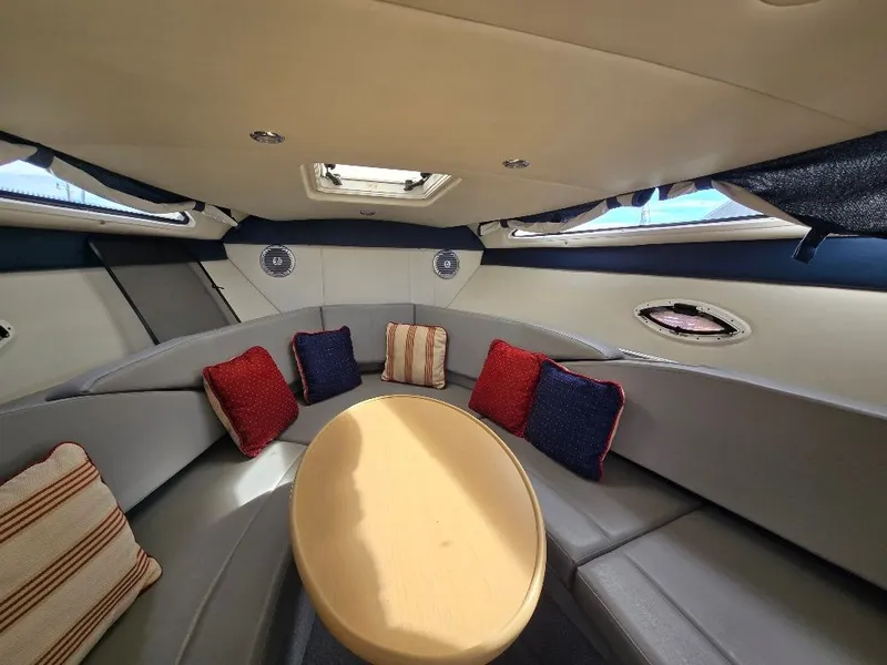 Slide: The Image of Interior of 2011 Bayliner 255 boat with cozy seating and colorful cushions. - 20