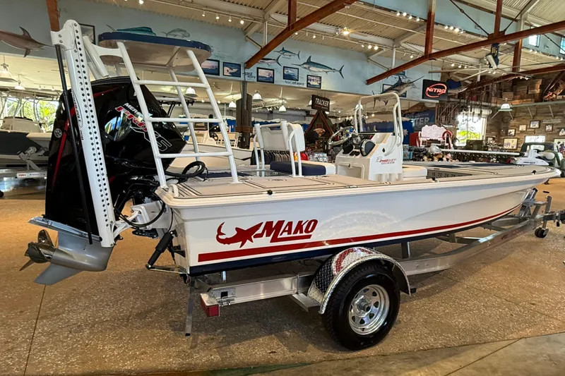 The Image of 2026 Mako 18 Pro Skiff Patriot Edition boat displayed in a showroom. - 0