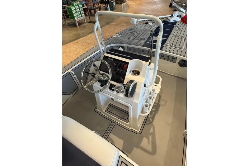 Slide: The Image of 2026 Mako 18 Pro Skiff Patriot Edition boat interior with steering console and controls. - 8