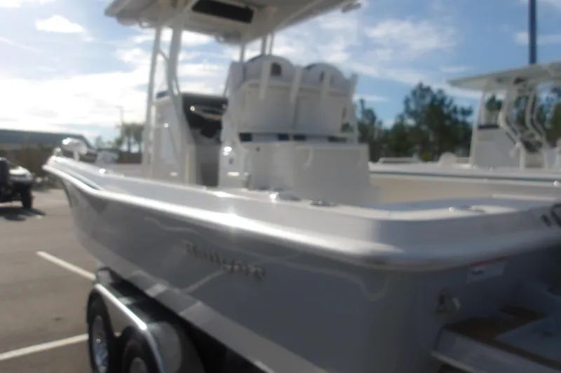 Slide: The Image of 2026 Ranger 2510 Bay boat on trailer in sunny outdoor setting. - 14