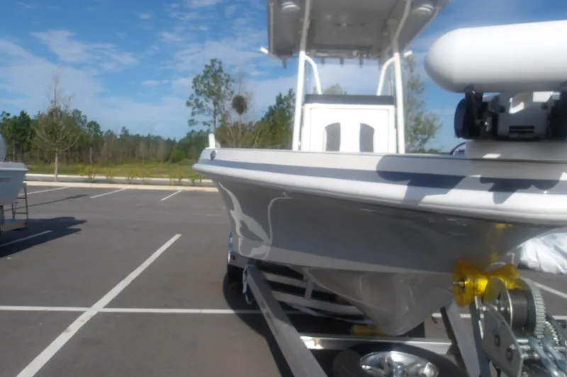 Slide: The Image of 2026 Ranger 2510 Bay boat on trailer in parking lot under clear sky. - 4