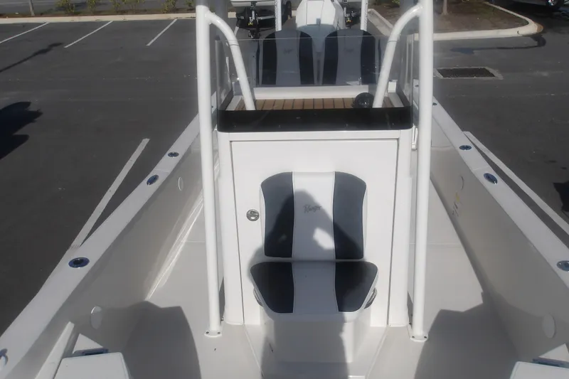 Slide: The Image of 2026 Ranger 2510 Bay boat interior with seating and console in a parking lot. - 21