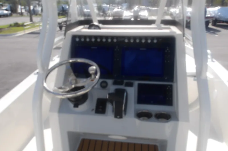 Slide: The Image of 2026 Ranger 2510 Bay boat dashboard with steering wheel and electronic displays. - 19