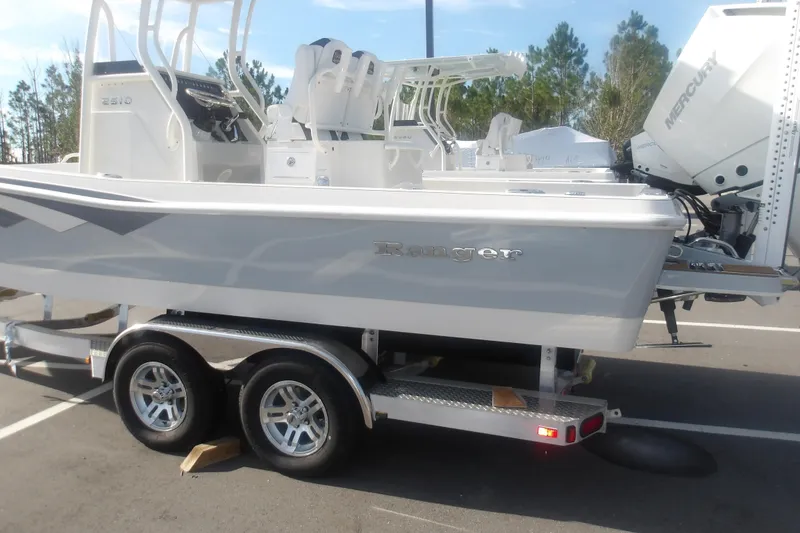 Slide: The Image of 2026 Ranger 2510 Bay boat on trailer, featuring sleek design and Mercury engine. - 5