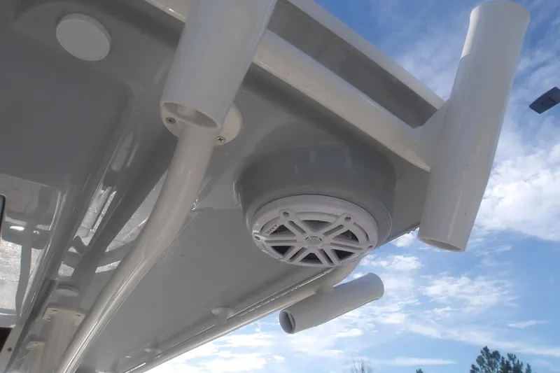 Slide: The Image of Ranger 2510 Bay 2026 boat with rod holders and speaker under clear sky. - 20