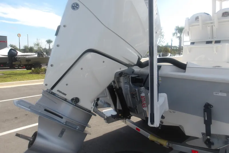 Slide: The Image of 2026 Ranger 2510 Bay boat engine and transom detail in a parking lot. - 9