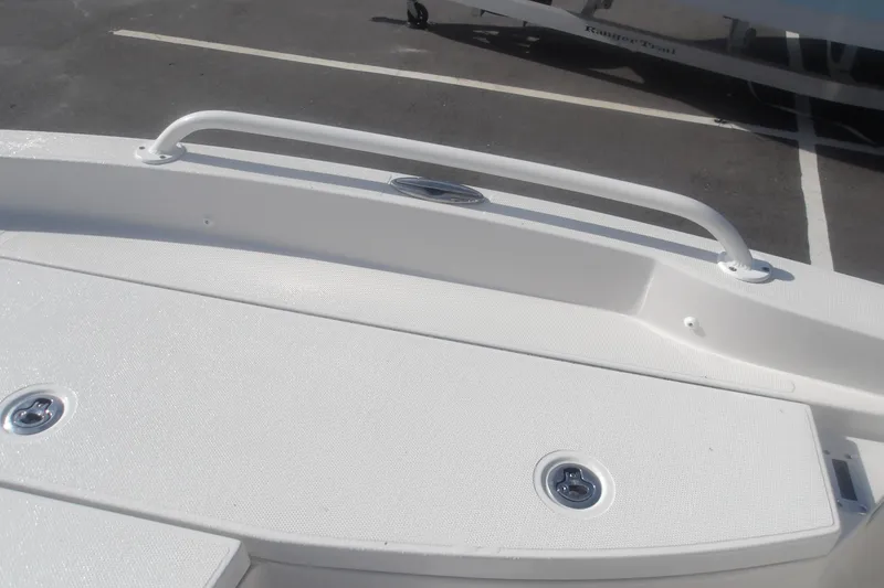 Slide: The Image of 2026 Ranger 2510 Bay boat deck with white textured surface and metal fittings. - 27