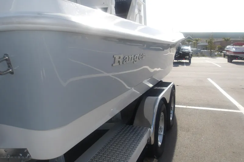 Slide: The Image of 2026 Ranger 2510 Bay boat on trailer in parking lot, side view. - 11