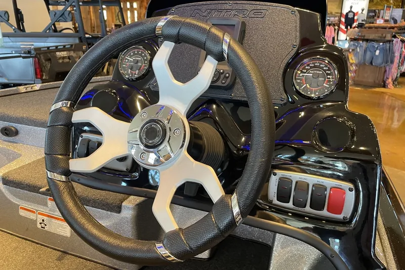Slide: The Image of Steering wheel and dashboard of a 2026 Nitro Z17 boat, featuring modern controls and gauges. - 1