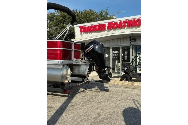 Slide: The Image of 2026 Sun Tracker Party Barge 18 DLX pontoon boat at Tracker Boating dealership. - 2