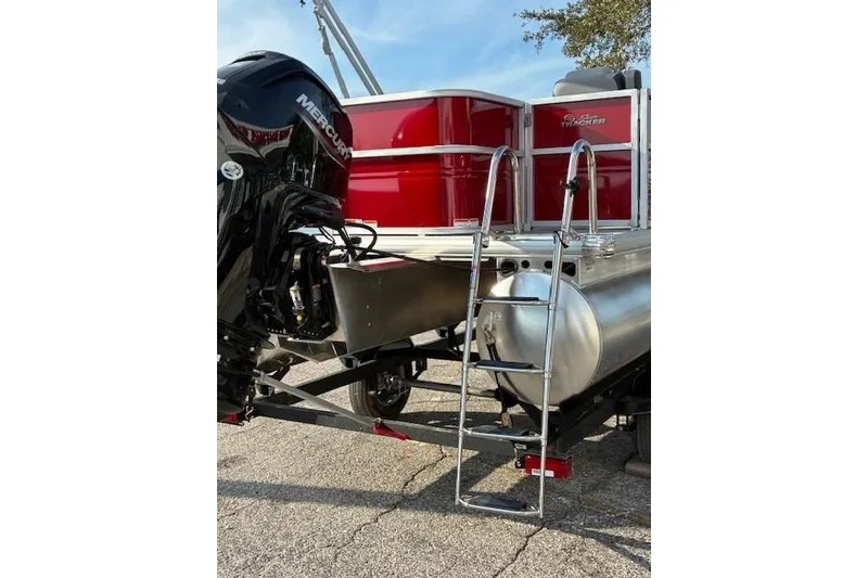 Slide: The Image of 2026 Sun Tracker Party Barge 18 DLX with Mercury engine and ladder, rear view. - 3