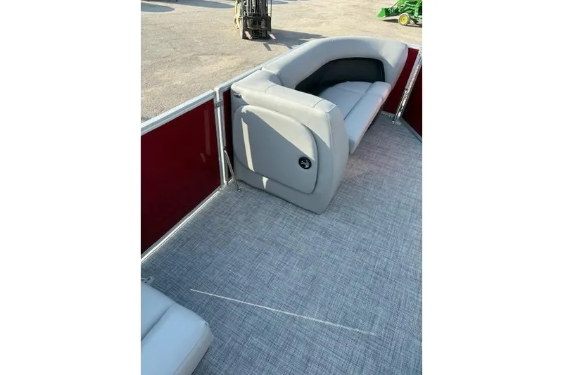 Slide: The Image of 2026 Sun Tracker Party Barge 18 DLX interior with gray seating and red paneling. - 5