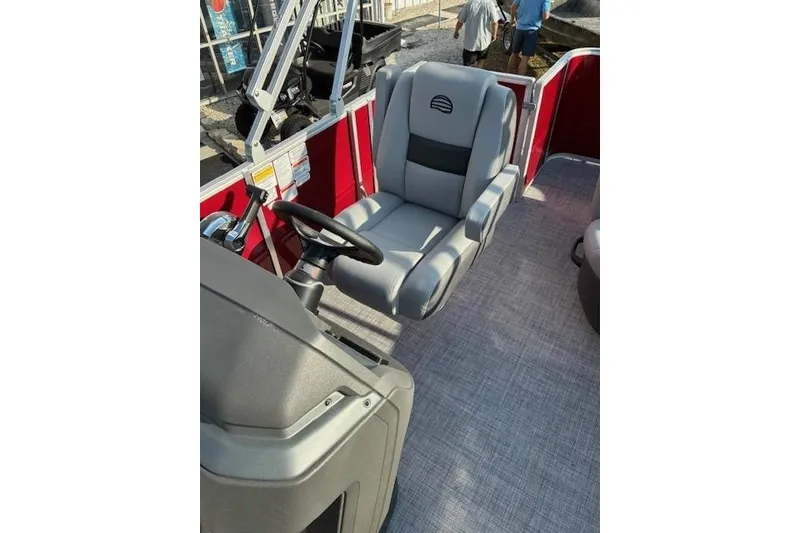 Slide: The Image of 2026 Sun Tracker Party Barge 18 DLX interior with steering wheel and captain's chair. - 6