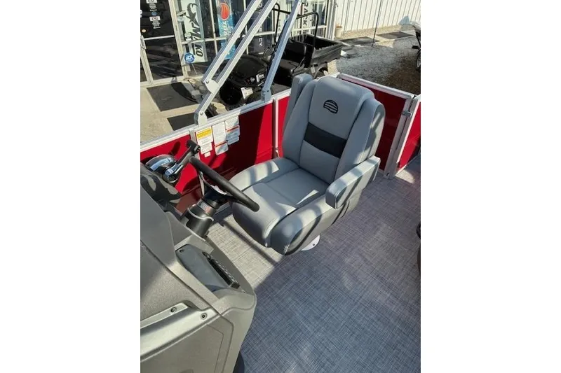 Slide: The Image of 2026 Sun Tracker Party Barge 18 DLX captain's chair and steering console. - 75