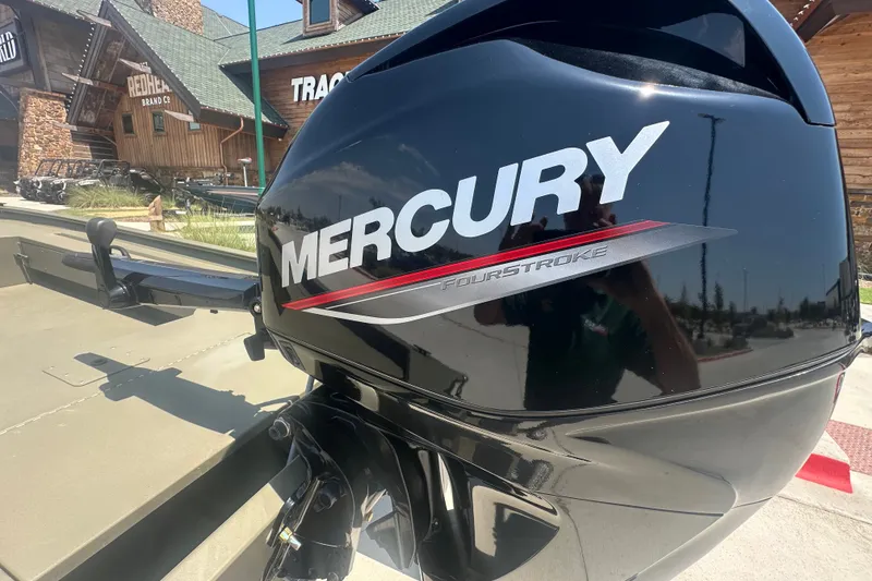 Slide: The Image of Mercury FourStroke engine on 2026 Tracker Grizzly 1654 T Sportsman boat, outdoor setting. - 15