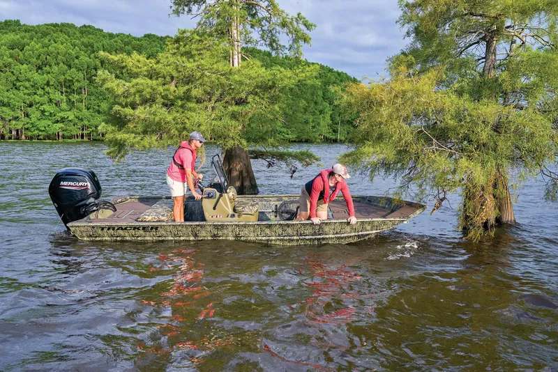 Slide: The Image of 2026 Tracker Grizzly 1860 CC boat with camo seating and windshield. - 53