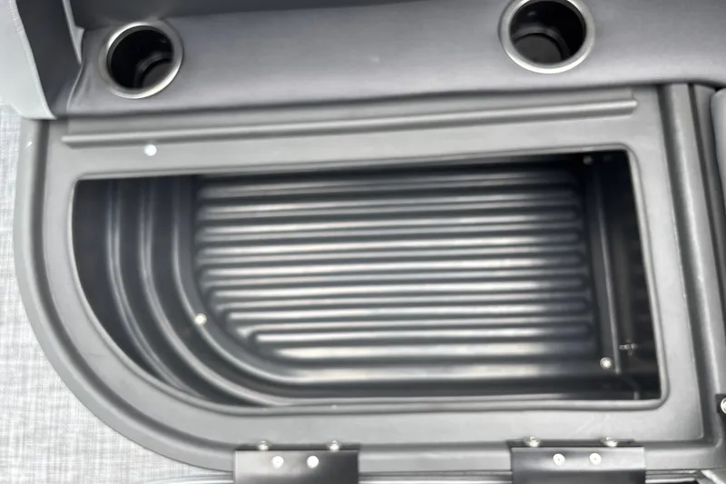 Slide: The Image of Storage compartment of 2026 Sun Tracker Party Barge 16 DLX with cup holders. - 21