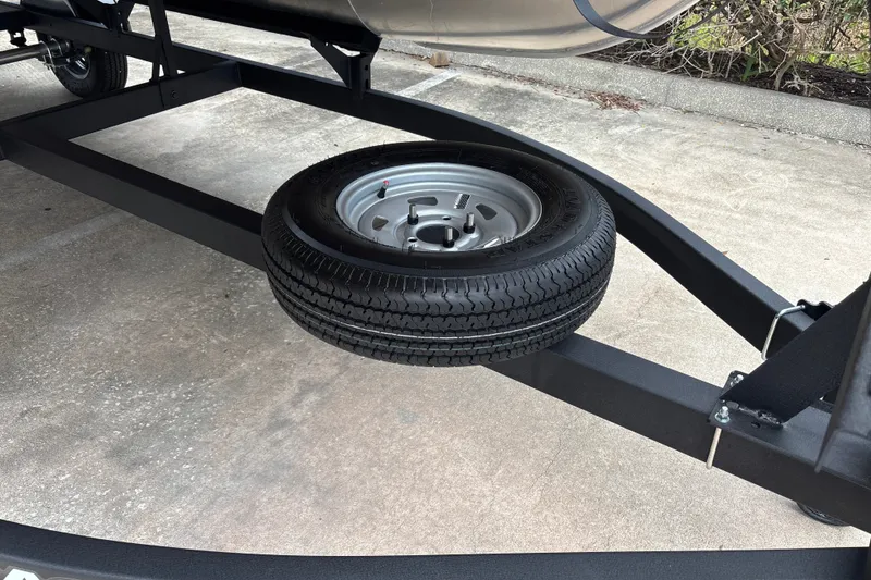 Slide: The Image of Trailer with spare tire for 2026 Sun Tracker Party Barge 16 DLX. - 29
