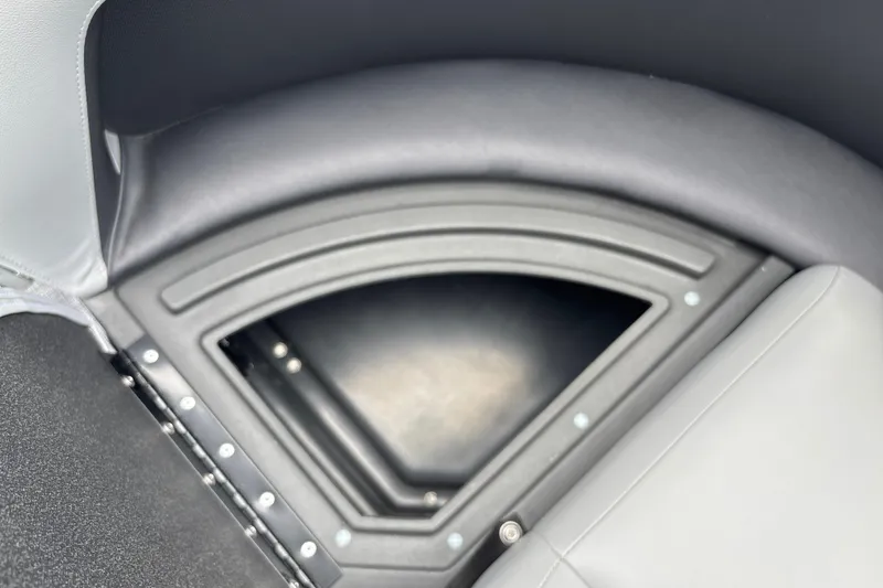 Slide: The Image of 2026 Sun Tracker Party Barge 16 DLX seating storage compartment, black and gray upholstery. - 23