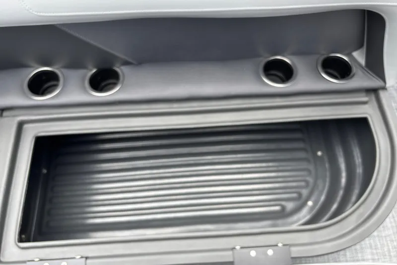 Slide: The Image of Interior storage compartment with cup holders on a 2026 Sun Tracker Party Barge 16 DLX. - 24