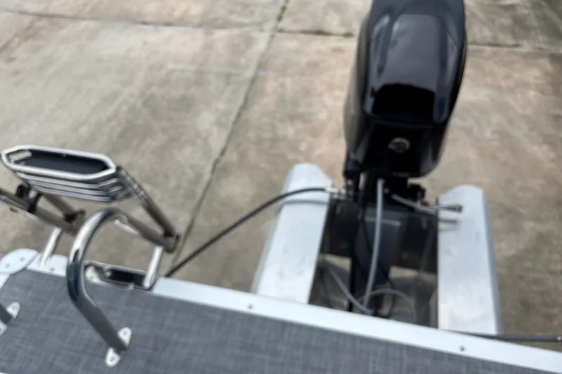 Slide: The Image of Rear view of 2026 Sun Tracker Party Barge 16 DLX with motor and ladder. - 27