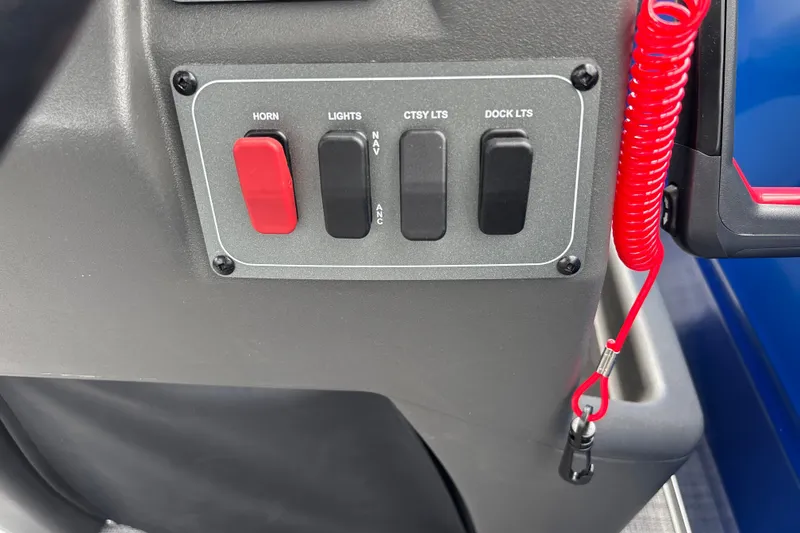 Slide: The Image of Control panel of 2026 Sun Tracker Party Barge 16 DLX with switches and safety lanyard. - 17