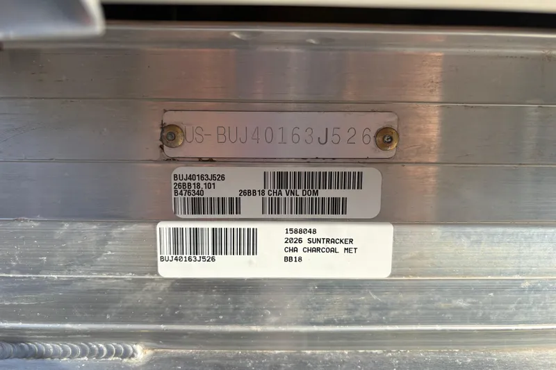 Slide: The Image of 2026 Sun Tracker Bass Buggy 18 DLX identification plate with serial numbers and barcodes. - 103