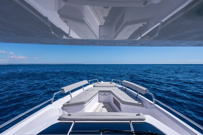 Slide: The Image of 2026 Axopar 29 Sun Top boat cruising on open blue sea under clear sky. - 6