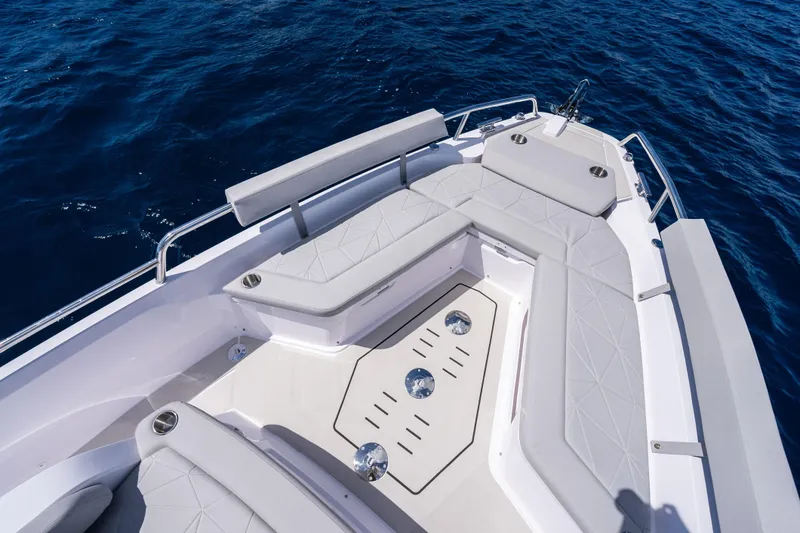 Slide: The Image of 2026 Axopar 29 Sun Top boat with spacious seating on open water. - 7