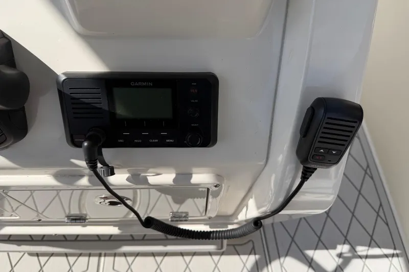 Slide: The Image of Garmin marine radio on 2021 Cobia 262 Center Console boat dashboard. - 11
