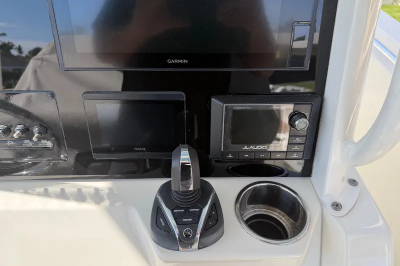 Slide: The Image of 2021 Cobia 262 Center Console dashboard with Garmin, Yamaha, and JL Audio controls. - 12