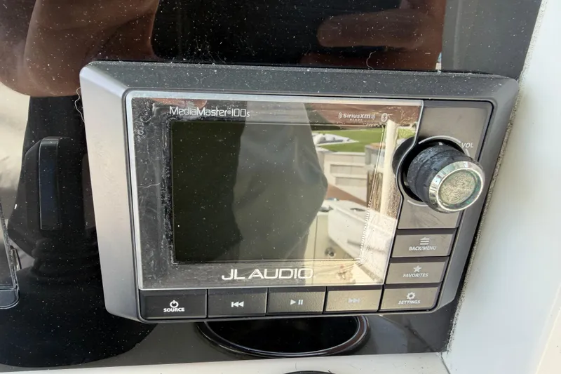 Slide: The Image of JL Audio MediaMaster 100s on 2021 Cobia 262 Center Console boat dashboard. - 13