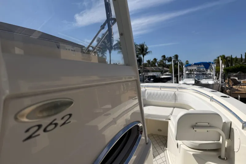 Slide: The Image of 2021 Cobia 262 Center Console boat docked under clear blue sky. - 16