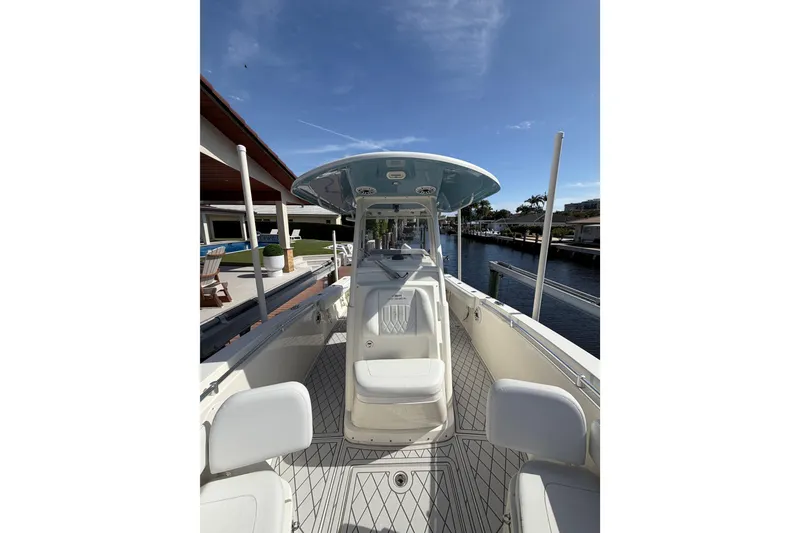 Slide: The Image of 2021 Cobia 262 Center Console boat docked by waterfront home. - 20