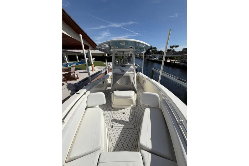 Slide: The Image of 2021 Cobia 262 Center Console boat docked, featuring spacious seating and sleek design. - 21