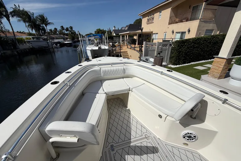 Slide: The Image of 2021 Cobia 262 Center Console boat docked near waterfront home. - 23