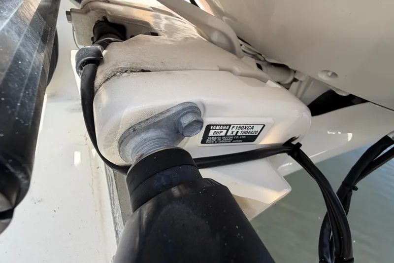 Slide: The Image of Close-up of Yamaha F150XCA engine on 2021 Cobia 262 Center Console boat. - 24