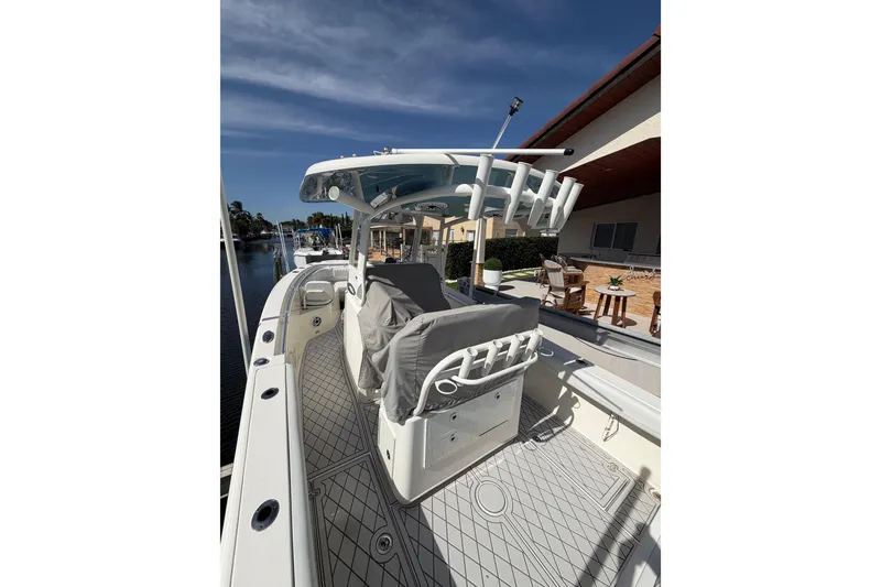 Slide: The Image of 2021 Cobia 262 Center Console boat docked, featuring spacious deck and modern design. - 26