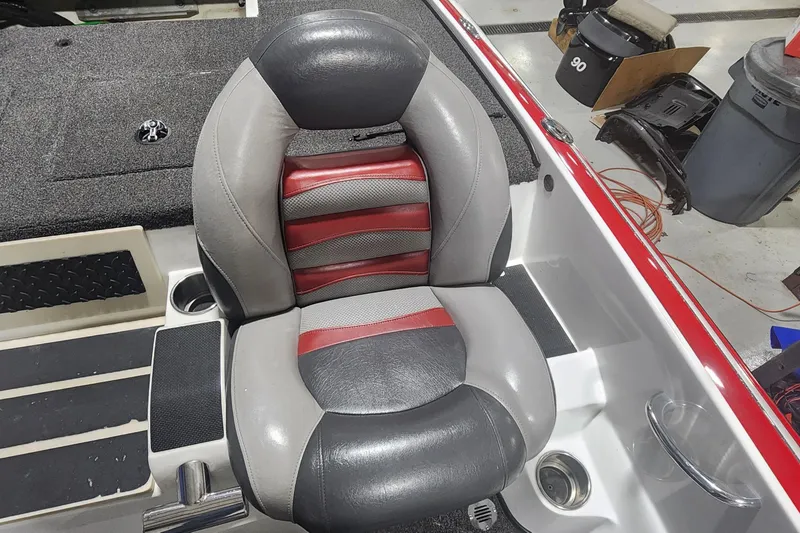 Slide: The Image of 2011 Nitro Z-8 boat seat with red, gray, and black upholstery in a workshop setting. - 10