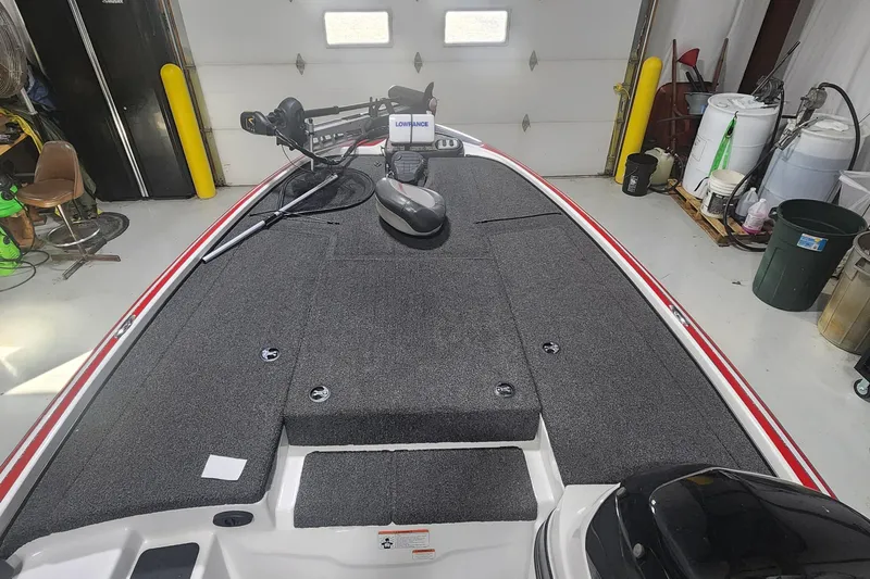 Slide: The Image of 2011 Nitro Z-8 boat interior with fishing equipment in a garage setting. - 7