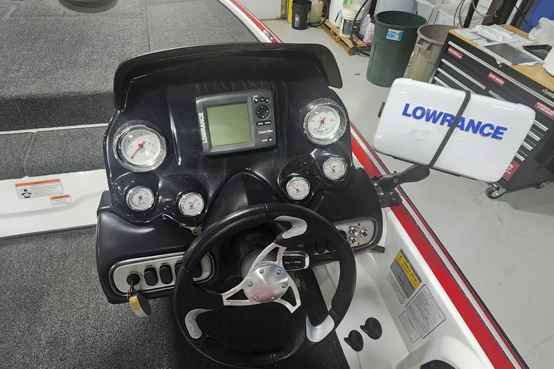 Slide: The Image of 2011 Nitro Z-8 boat dashboard with Lowrance fishfinder and multiple gauges. - 8