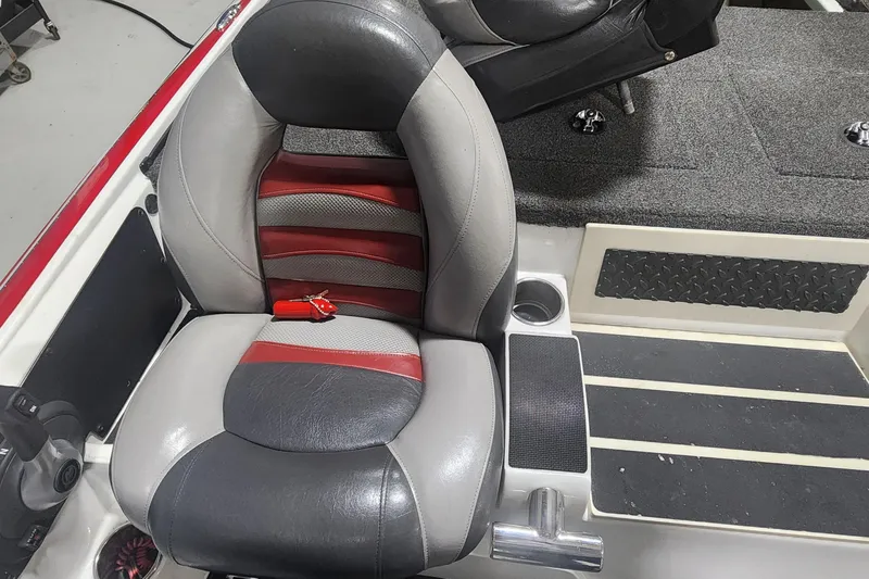 Slide: The Image of 2011 Nitro Z-8 boat seat with red and gray upholstery, cup holder, and textured flooring. - 9