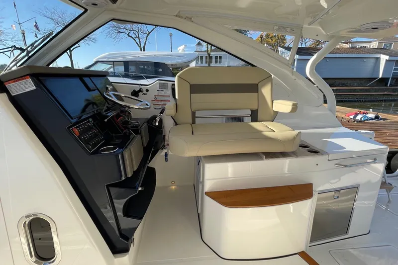 Slide: The Image of 2020 Pursuit DC 365 Dual Console boat interior with helm and seating area. - 12