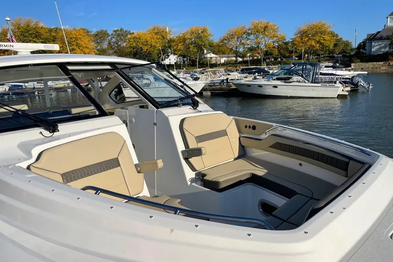 Slide: The Image of 2020 Pursuit DC 365 Dual Console boat docked in a marina with autumn trees. - 16