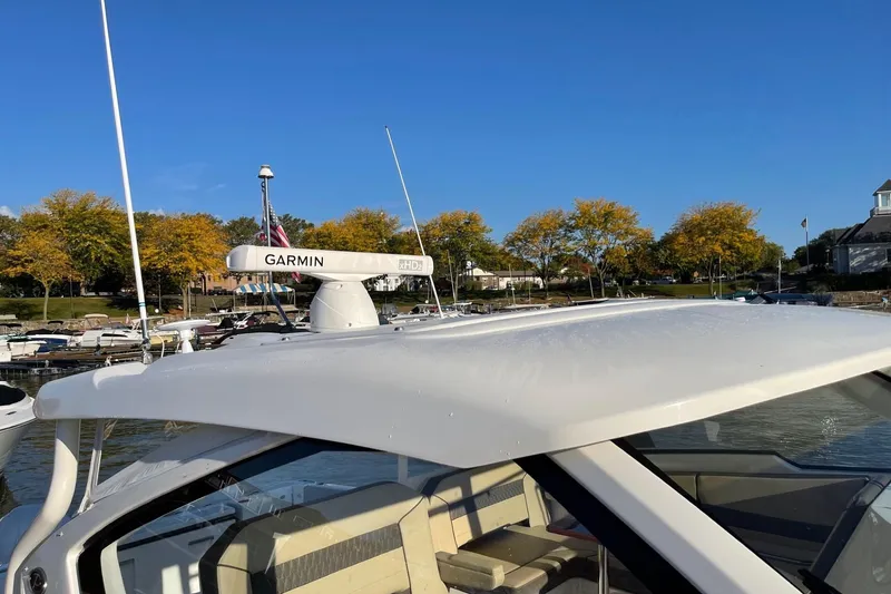 Slide: The Image of 2020 Pursuit DC 365 Dual Console boat with Garmin radar, docked near autumn trees. - 17